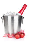 Champagne bottle in ice bucket and christmas decor