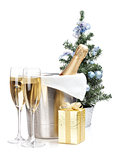 Champagne bottle in ice bucket, two glasses and christmas gift
