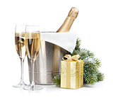 Champagne bottle in ice bucket, two empty glasses and christmas 