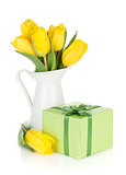 Yellow tulips in a jug and gift box