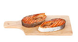 Grilled salmon steak on cutting board