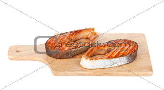 Grilled salmon steak on cutting board