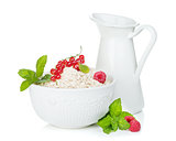 Fresh oat flakes with berries and milk jug