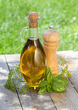 Olive oil bottle, pepper shaker and herbs