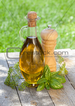 Olive oil bottle, pepper shaker and herbs