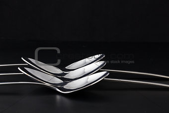 Spoons on a black table