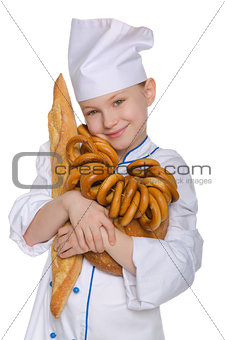 Smiling baker with bread and bagels