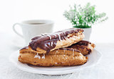 Chocolate eclairs on white plate 