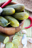 Pickled cucumbers in wooden bowl