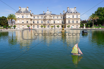 Traditional small wooden sailing boat in the pond of park Jardin
