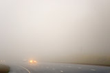 Road and a car in fog