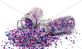 Small Glass Jars filled with Multicolored Balls of Bead
