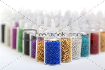 Small Glass Jars filled with Balls of Bead