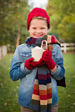 Young Boy in Warm Clothing Holding Hot Cocoa Mug Outside