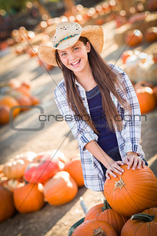 Preteen Girl Playing with a Wheelbarrow at the Pumpkin Patch 
