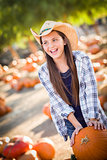 Preteen Girl Playing with a Wheelbarrow at the Pumpkin Patch 