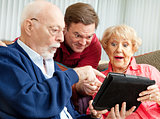Seniors and Adult Son with Tablet PC