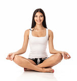 Happy young woman sitting in lotus position