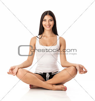 Happy young woman sitting in lotus position