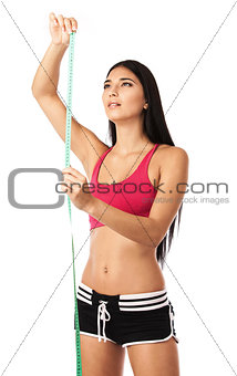 Young girl with a measuring tape over white