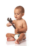 Cute little boy holding an adjustable spanner over white