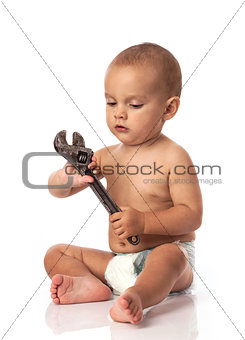 Cute little boy holding an adjustable spanner over white