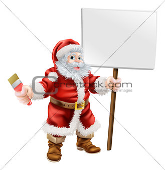 Santa holding paintbrush and sign