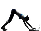 woman exercising yoga using computer laptop silhouette