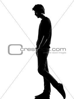 young man silhouette sad walking