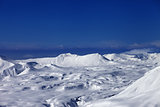 Snowy plateau and off-piste slope at sun day