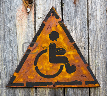 Disabled Icon on Rusty Warning Sign.