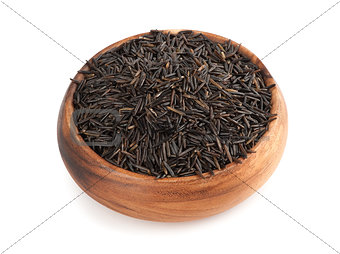 raw wild rice in wooden bowl