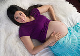 Pregnant Woman Relaxing Laying In Bed Expecting New Child