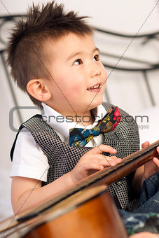 Happy Two Year Old Boy Interested in Arts and Music