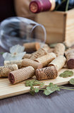 Wine corks on the table with glass and bottle on the background