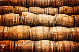 Stacked pile of old vintage whisky and wine wooden barrels
