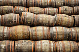 Stacked pile of old whisky and wine wooden barrels