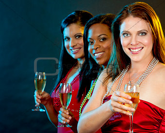 women holding champagne glasses