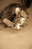 mechanic welding a motorcycle exhaust