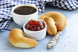 strawberry jam and bread rolls with a cup of coffee for breakfast