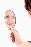 Young Woman Looking at her Reflection in Old Mirror
