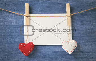 decorative hearts hanging on the rope against blue wood wall