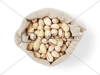 roasted salty pistachios nuts in sack bag from above