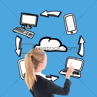 Businesswoman pointing at illustrated laptop