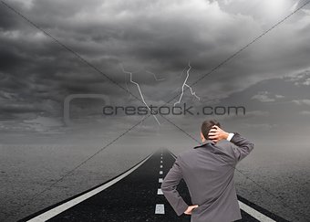 Businessman scratching his head hand on hip