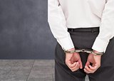 Close up on young businessman wearing handcuffs