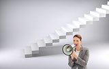 Composite image of serious businesswoman talking on a megaphone