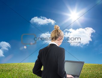 Blonde businesswoman using laptop