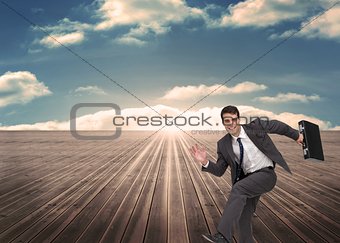 Cheerful man holding a suitcase and running