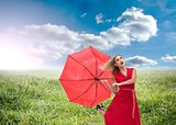 Beautiful woman wearing red dress holding umbrella